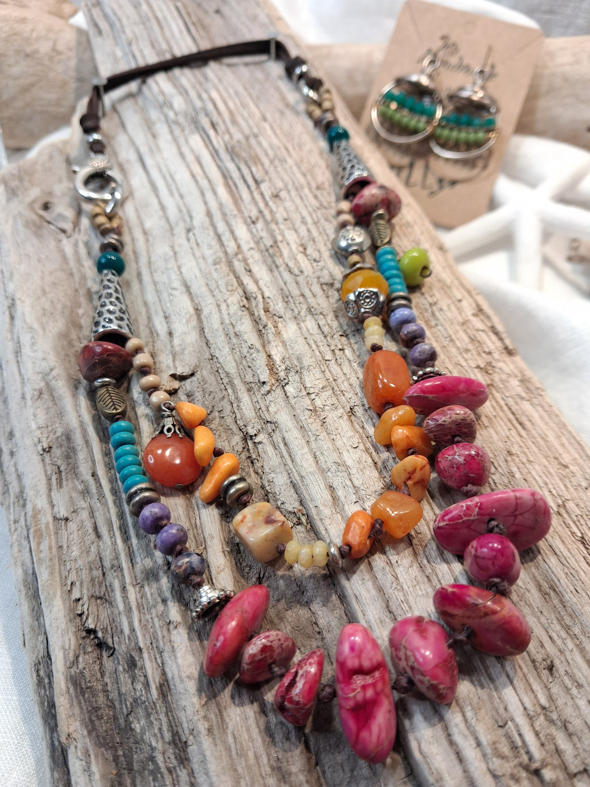 Amber and cranberry orange beaded necklace with multicolored gemstone beads and metal accents, handmade by Melly