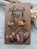 Amber and earthy beaded rocky dangle earrings featuring polished stones and wire loops, handmade by Melly