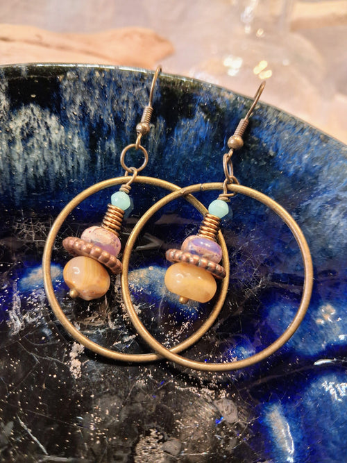 Amber and lavender wire wrapped hoop earrings featuring beaded charms, handmade by Melly