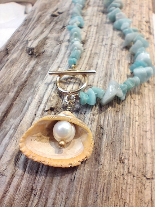 Blue chip necklace with a seashell pendant and white pearl, handmade by Melly