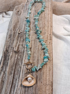 Blue aquamarine beaded chip necklace featuring a mother of pearl shell pendant, handmade by Melly