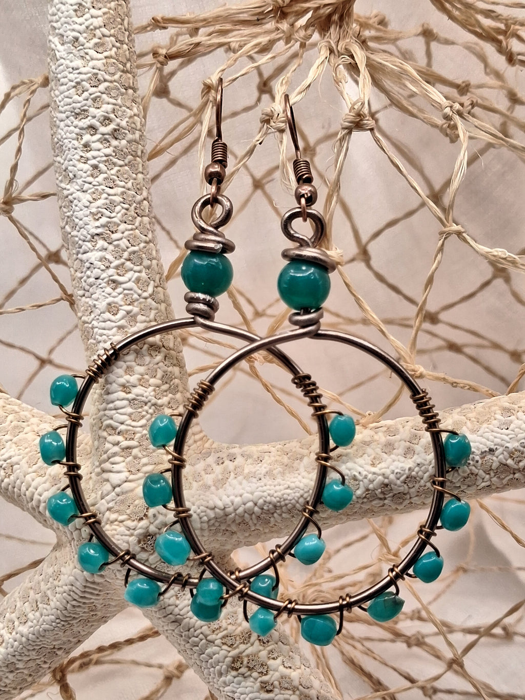 Aquamarine blue beaded hoop earrings with copper wire wrapping, handmade by Melly