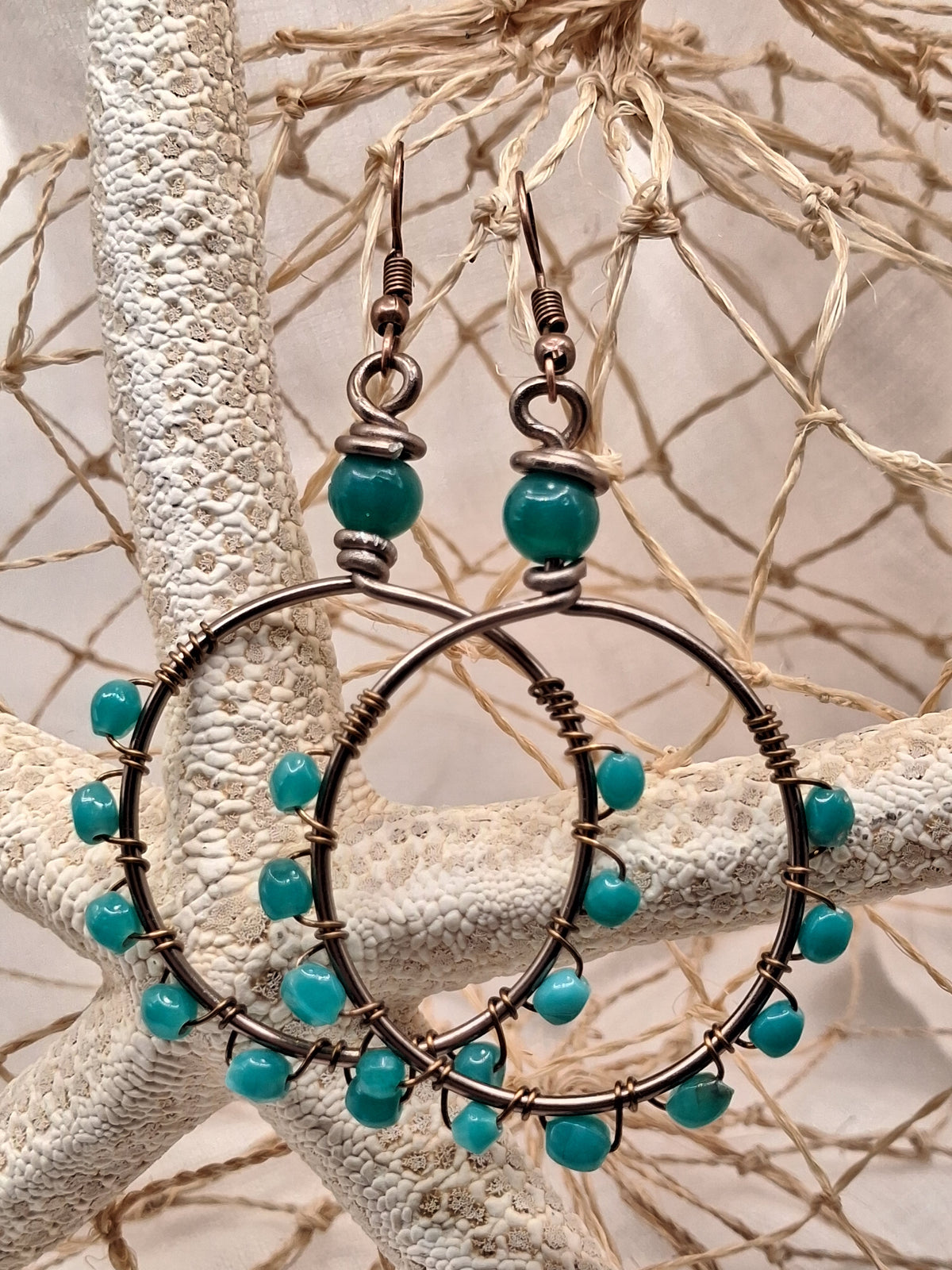 Aquamarine blue beaded hoop earrings with copper wire wrapping, handmade by Melly