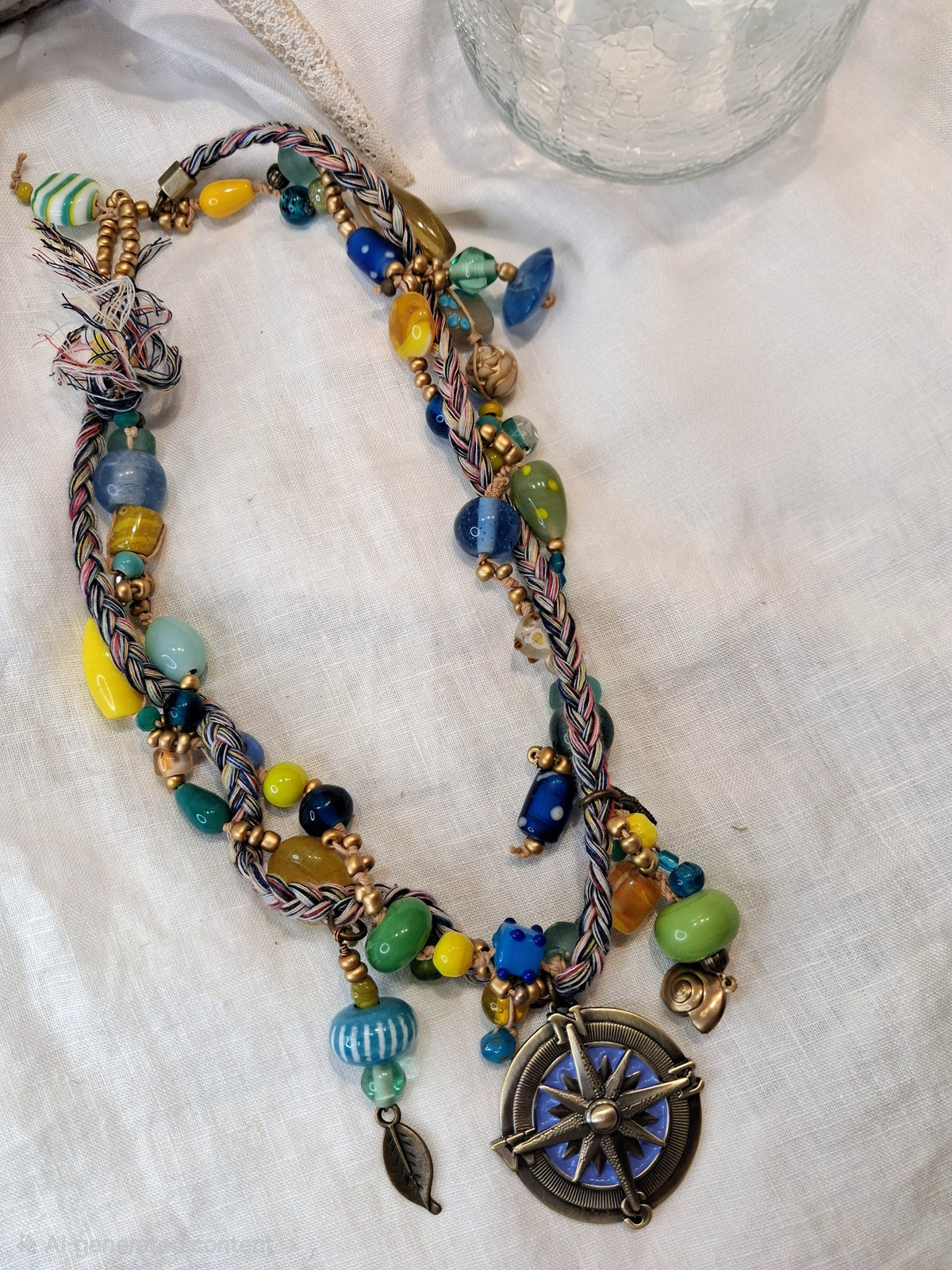 Cobalt, teal, and yellow beaded Nautica necklace with glass beads and a compass pendant, handmade by Melly