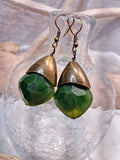Emerald green bishop dangle earrings with faceted stones and bronze metal caps, handmade by Melly