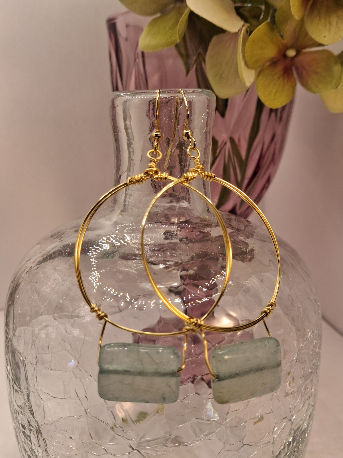 Ice blue rectangular stone and gold wire wrapped small hoop earrings, handmade by Melly
