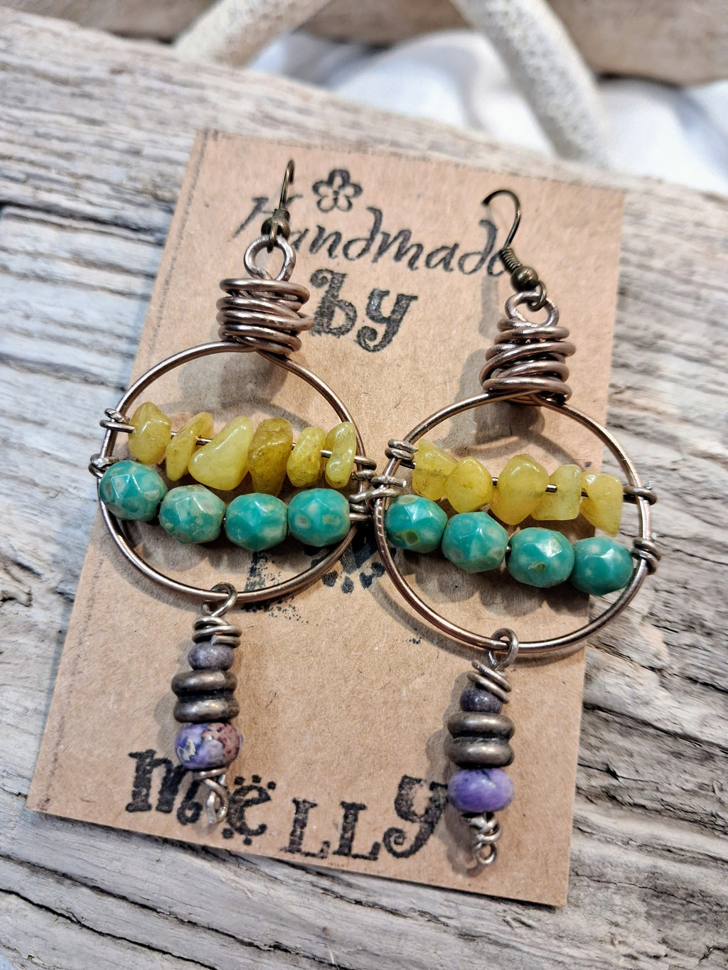 Wire wrapped hoop earrings featuring lavender, teal, and lime beads, handmade by Melly