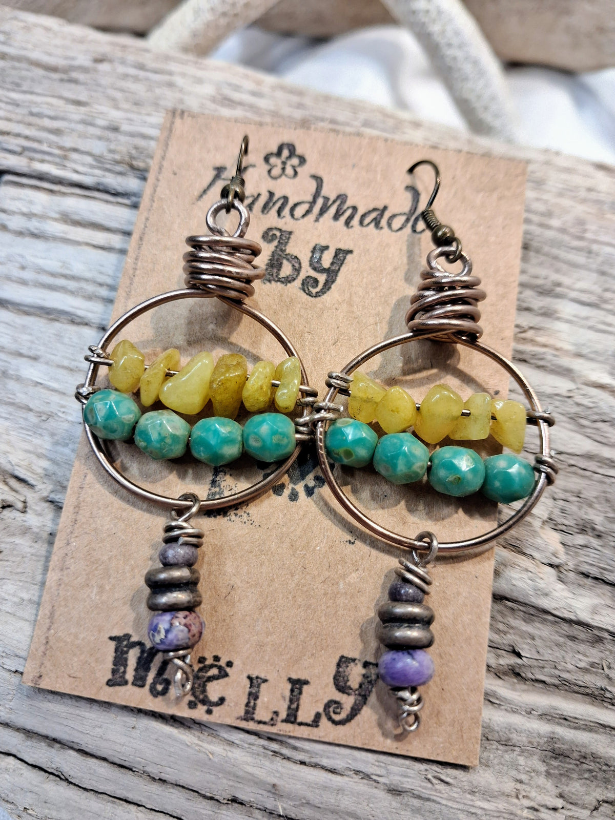 Wire wrapped hoop earrings featuring lavender, teal, and lime beads, handmade by Melly