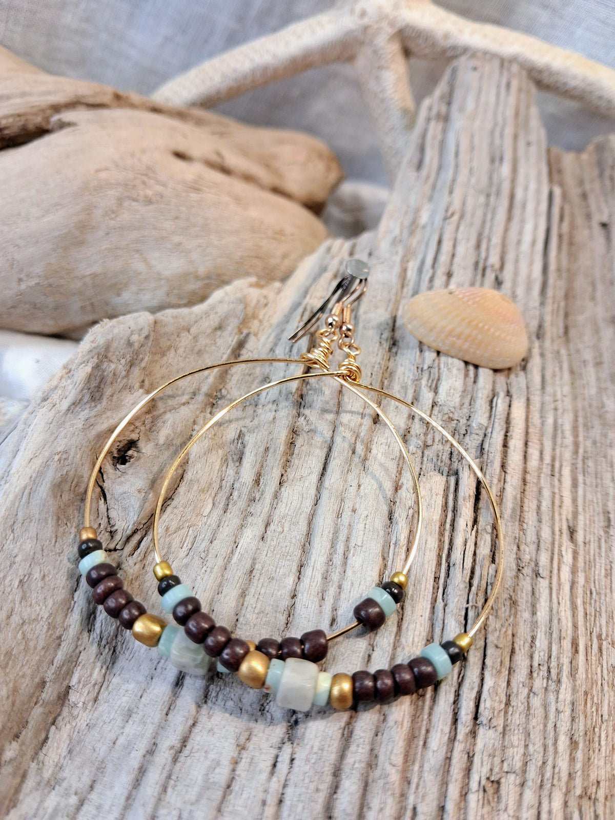 Light blue and brown beaded beach time hoop earrings featuring metal wire, handmade by Melly