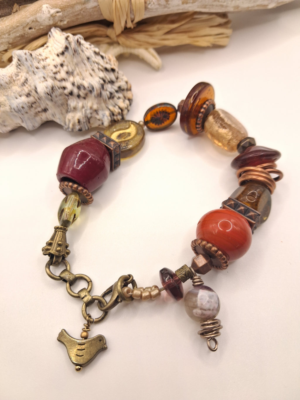 Red and wine red beaded coffee bean charm bracelet featuring assorted glass beads and metal components, handmade by Melly.
