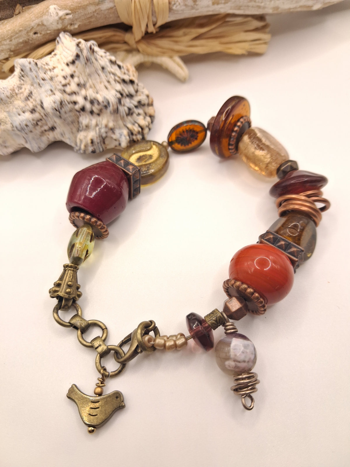 Red and wine red beaded coffee bean charm bracelet featuring assorted glass beads and metal components, handmade by Melly.
