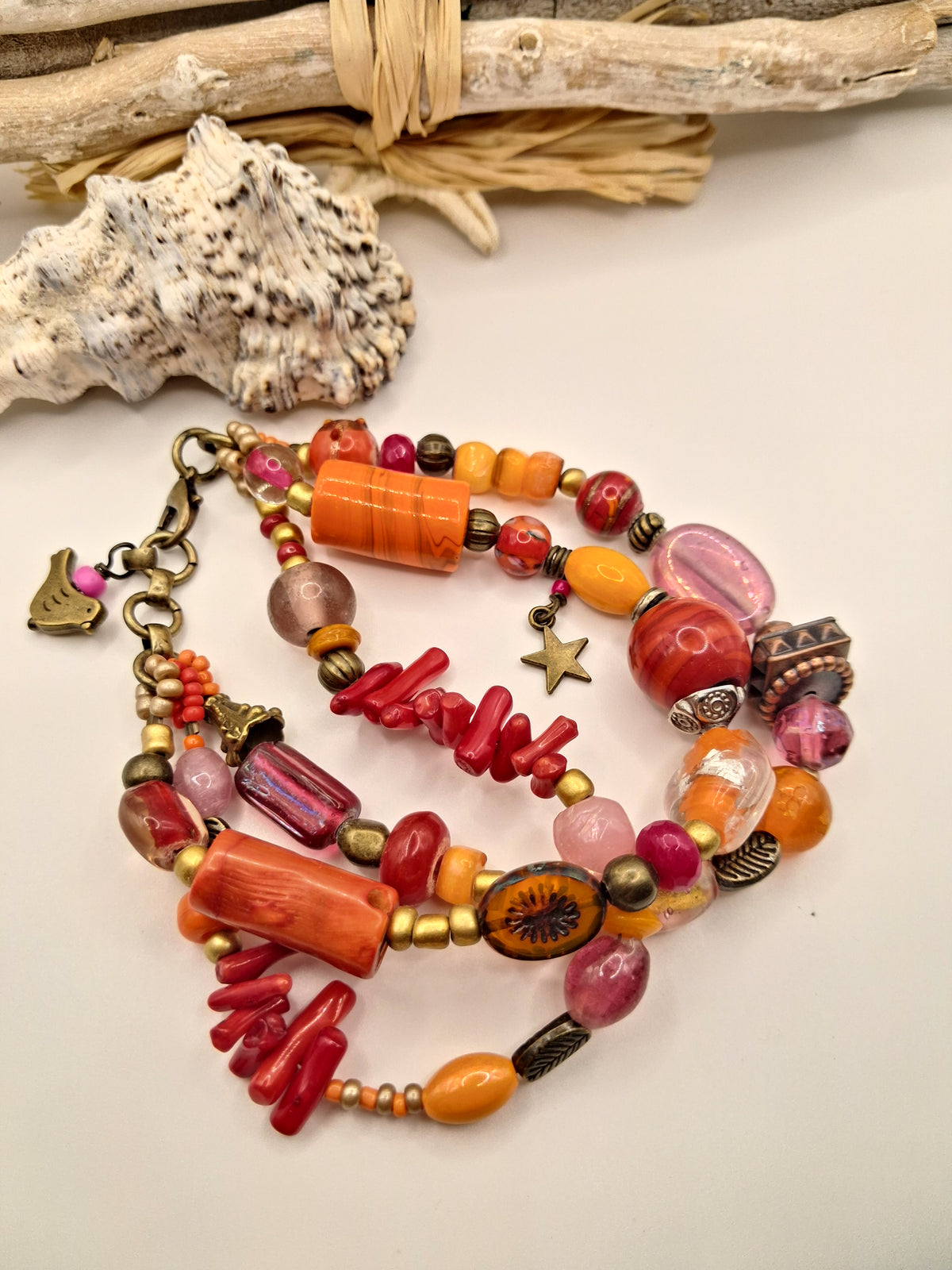 Red, orange, and purple beaded charm bracelet with little bird charm and mixed beads, handmade by Melly