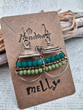 Teal and lime beaded wire wrapped hoop earrings featuring stacked metal coils, handmade by Melly
