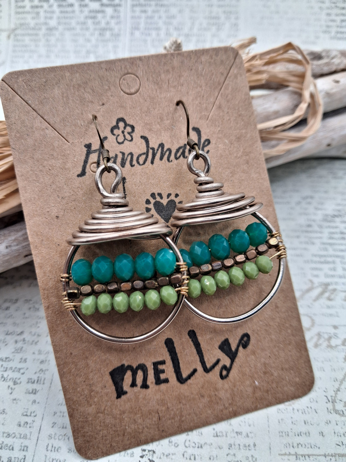 Teal and lime beaded wire wrapped hoop earrings featuring stacked metal coils, handmade by Melly