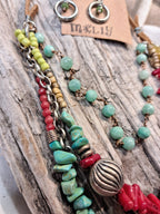 Multi-color beaded statement necklace and earrings featuring turquoise and red stones, handmade by Melly