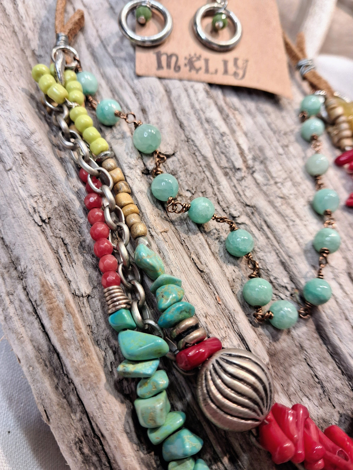 Multi-color beaded statement necklace and earrings featuring turquoise and red stones, handmade by Melly