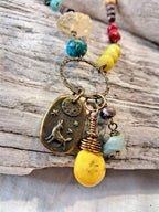 Multi-color beaded pendant necklace with gemstone beads and brass charms, handmade by Melly