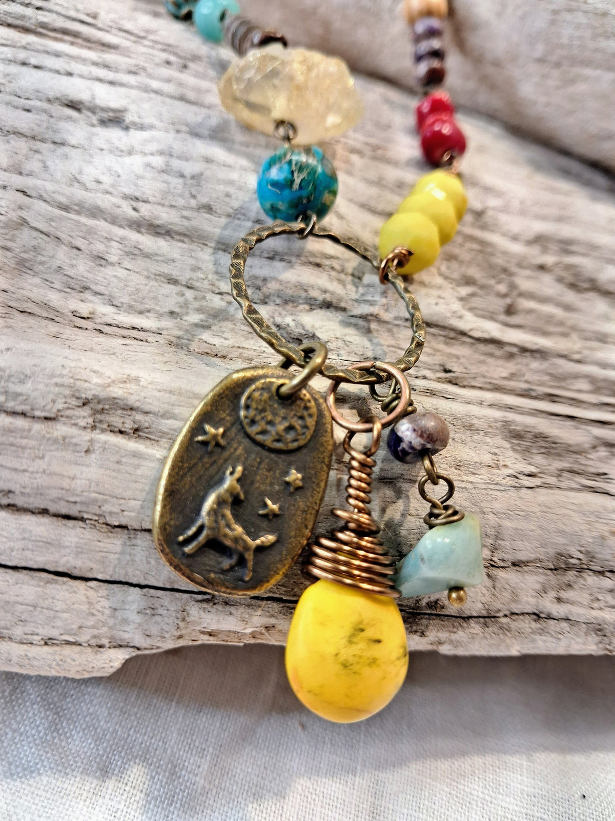 Multi-color beaded pendant necklace with gemstone beads and brass charms, handmade by Melly