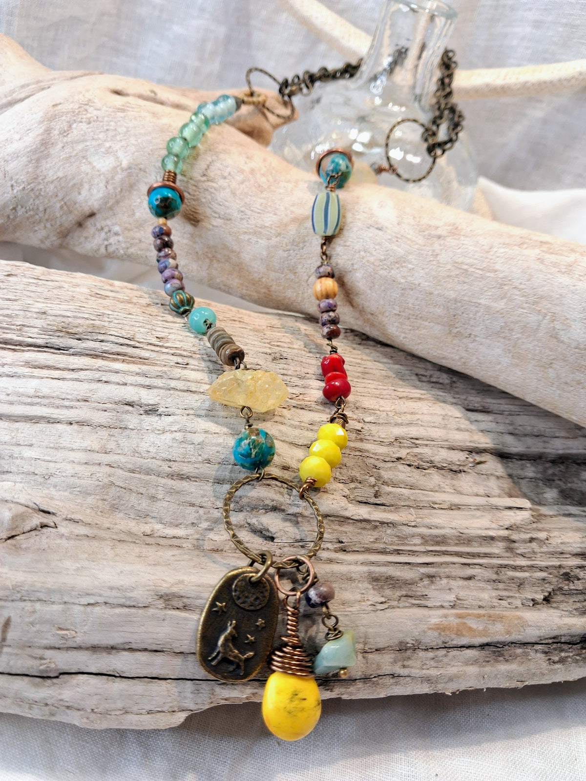 Turquoise and amber beaded necklace with gemstone beads, metal charms, and chain, handmade by Melly
