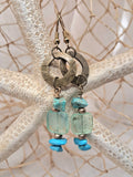 Turquoise and aquamarine beaded Sami dangle earrings featuring natural stones and metal rings, handmade by Melly