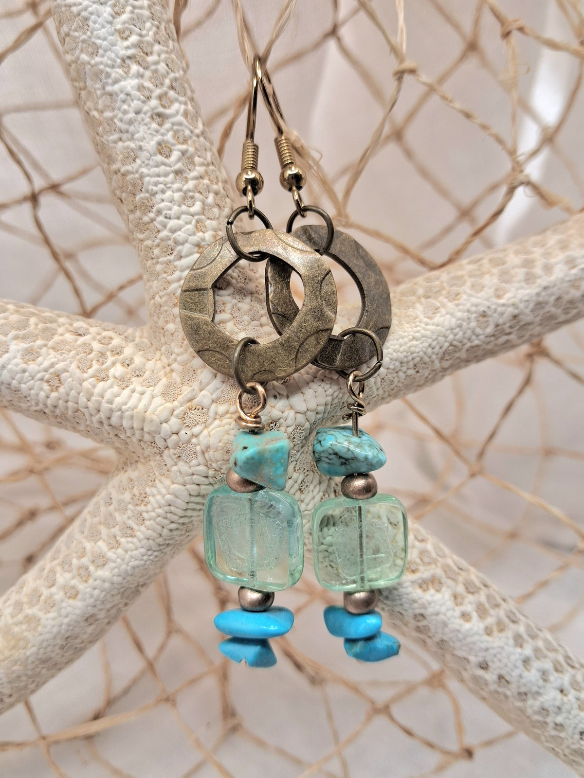 Turquoise and aquamarine beaded Sami dangle earrings featuring natural stones and metal rings, handmade by Melly