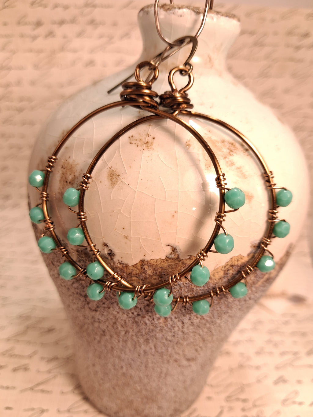 Turquoise and copper wire wrapped hoop earrings with faceted beads, handmade by Melly