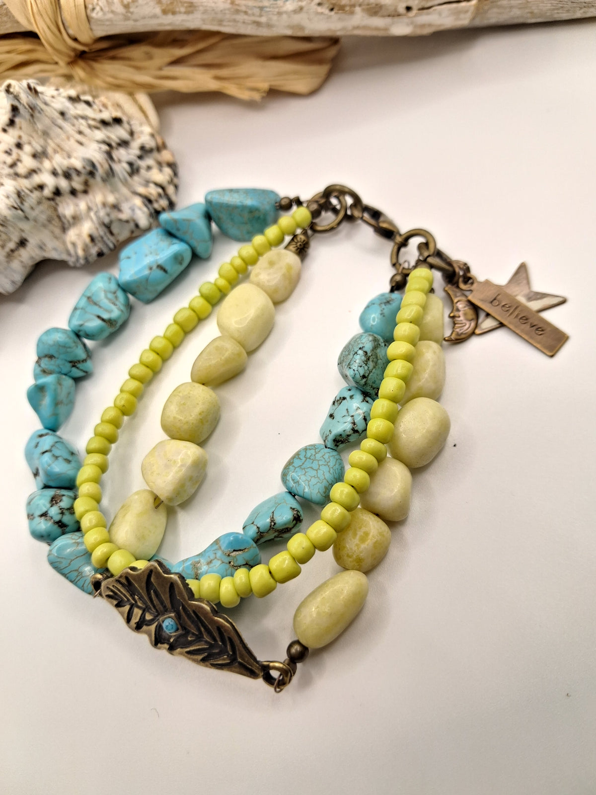 Turquoise and light green beaded bracelet with a believe charm, handmade by Melly