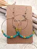 Turquoise and lime beaded beach hoop earrings with glass beads and wire, handmade by Melly.
