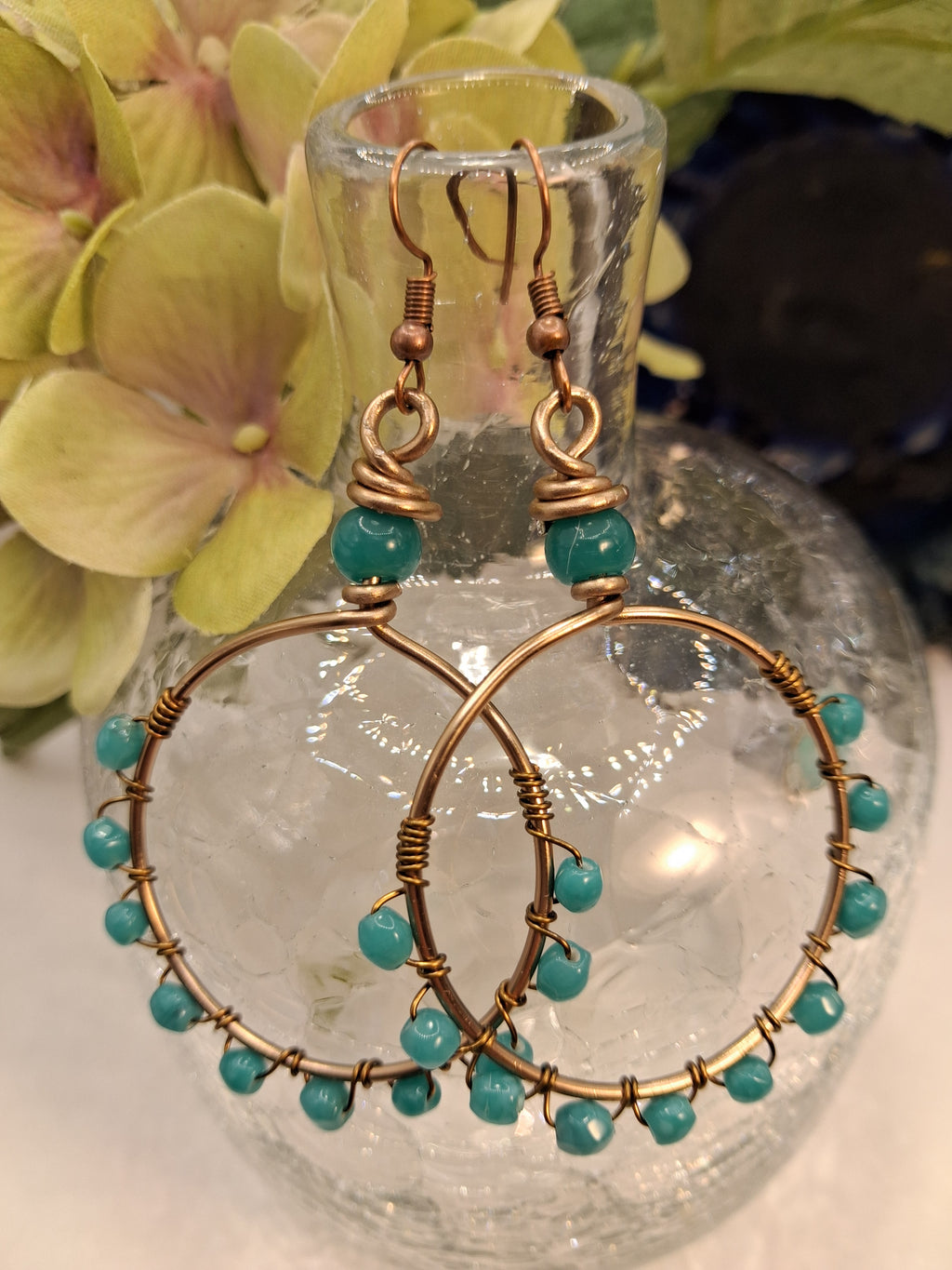 Turquoise and teal wire wrapped LoLa hoop earrings featuring beaded copper metalwork, handmade by Melly