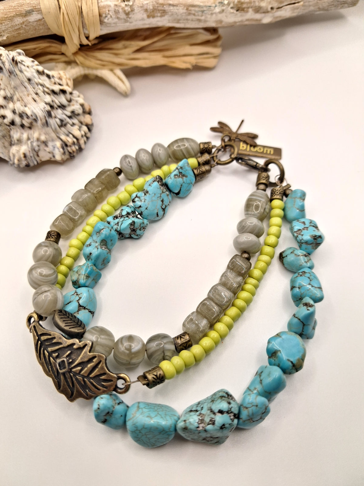 Turquoise, lime, and light grey multi-strand beaded charm bracelet with leaf detail, handmade by Melly