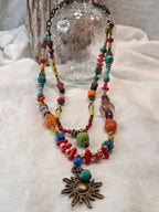 Turquoise, lime, and red beaded sunset necklace with brass sun pendant, handmade by Melly