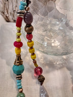 Multi-color beaded necklace featuring glass and metal beads in vibrant shades, handmade by Melly