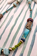 Turquoise beaded necklace featuring mixed stone beads and metallic accents, handmade by Melly.