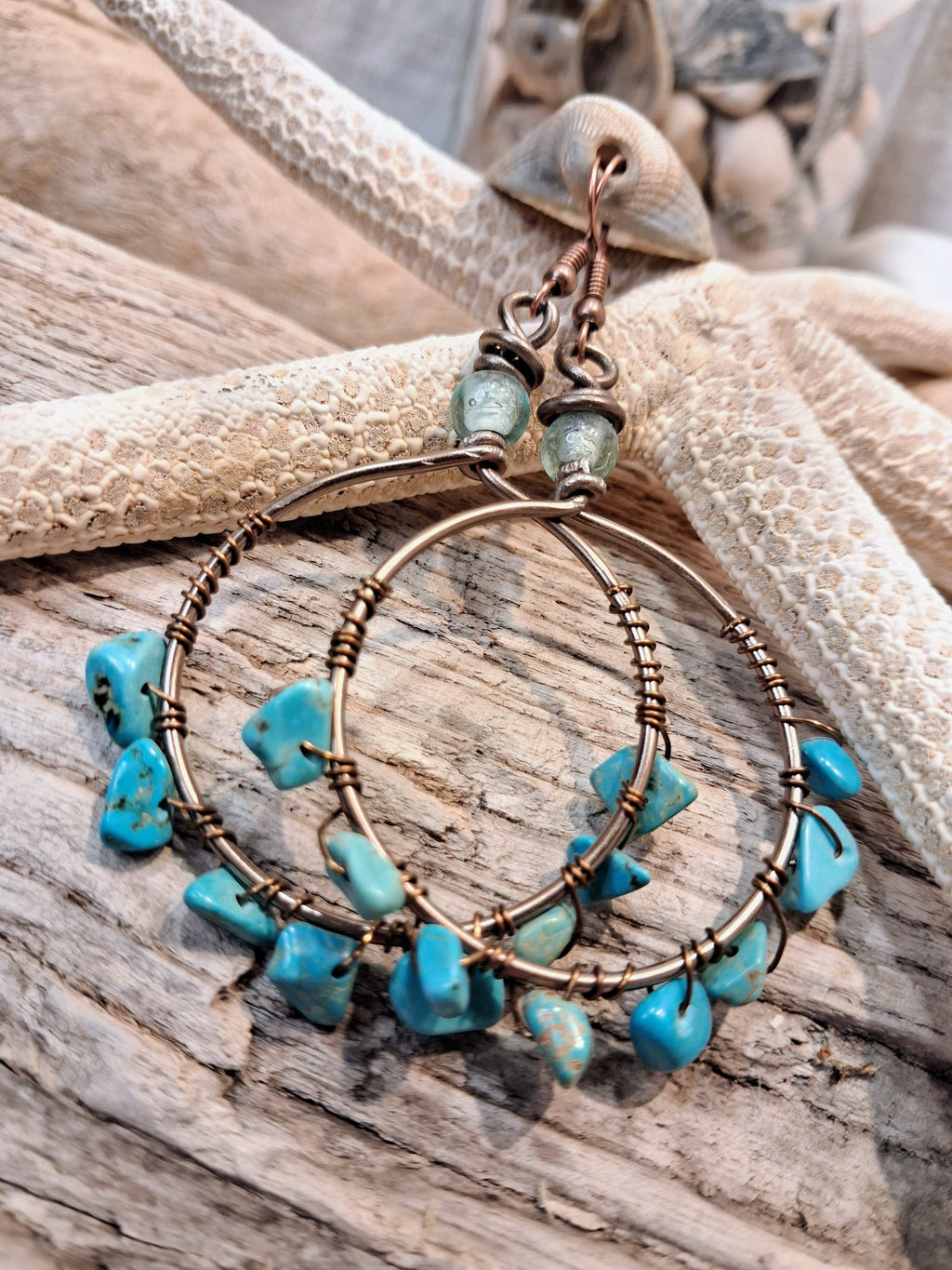 Turquoise wire wrapped hoop earrings featuring copper wire and natural stone beads, handmade by Melly