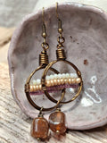 White microfaceted glass beads and amber-colored quartz dangle earrings handmade by Melly